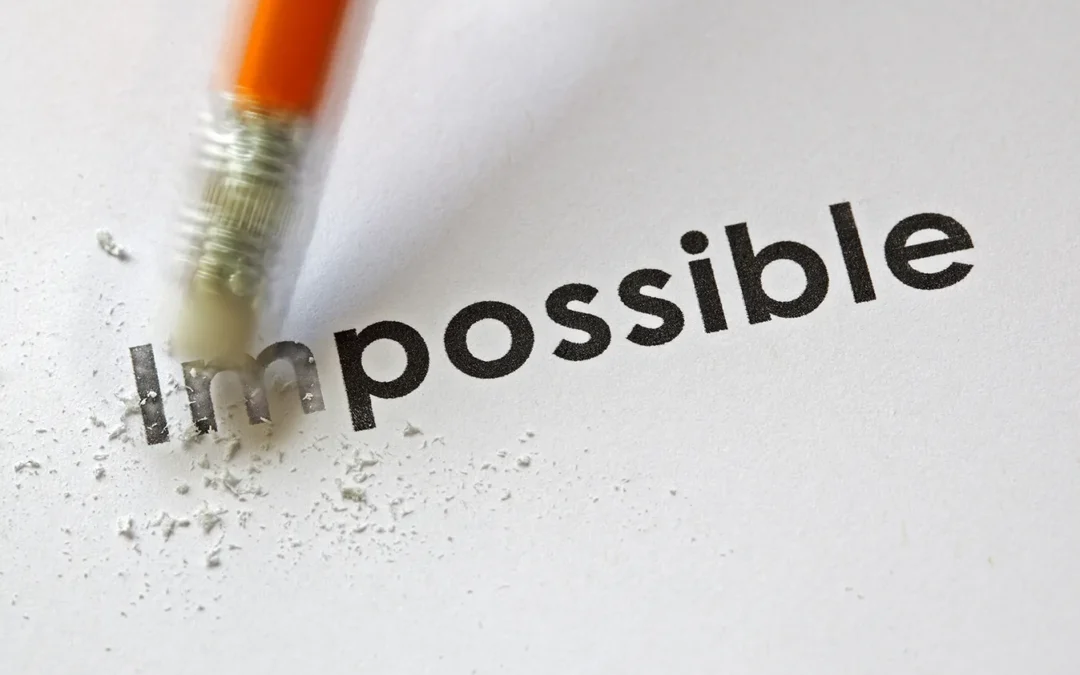 the word impossible with a pencil erasing the im